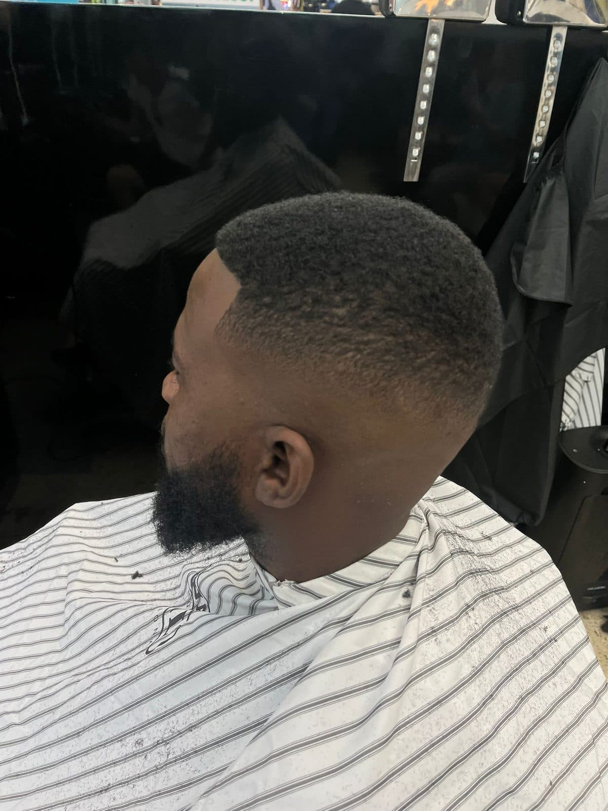 Textured fade with a sharp line up and beard blend